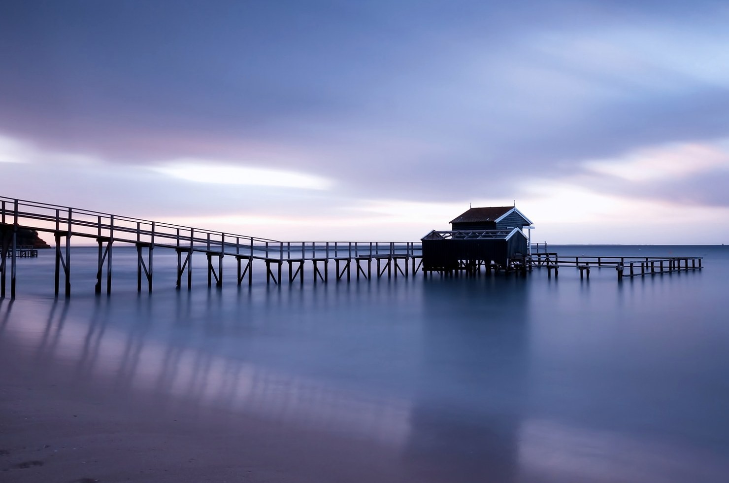 Evening over a pier and boathouse; illustrative waterfront image